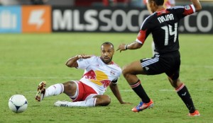 New York Red Bulls forward Thierry Henry (14) knocks a pass forward to teammate Joel Lindpere (20), not pictured, and past D.C. United midfielder Andy Najar (14) during first-half action at RFK Stadium in Washington, D.C., Wednesday, August 29, 2012. (Chuck Myers/MCT)