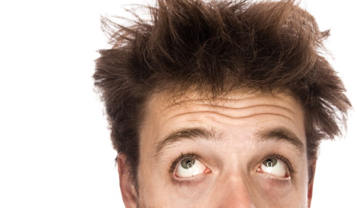Young adult with mixed hairs and looking tired isolated on white background