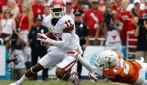 Oklahoma Sooners wide receiver Lacoltan Bester (11) tries to shake Texas Longhorns safety Mykkele Thompson (2). The Texas Longhorns defeated the Oklahoma Sooners, 36-20, at the Cotton Bowl in Dallas, Texas, on Saturday, October 12, 2013. (Richard W. Rodriguez/Fort Worth Star-Telegram/MCT)