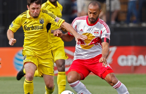 The Columbus Crew's Danny O'Rourke (5) battles for the ball against New York Red Bulls forward Thierry Henry (14) during the first half at Crew Stadium in Columbus, Ohio, Saturday, May 4, 2013. The Red Bulls defeated the Crew, 1-0. (Kyle Robertson/Columbus Dispatch/MCT)