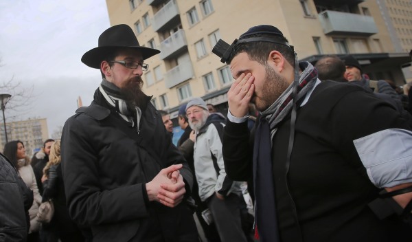 Two Orthodox Jews prepare for prayer at the scene of the hostage-taking in the east of Paris, France, 12 January 2015. The four Jewish victims of the hostage-taking in a kosher supermarket in Paris will be interred in Jerusalem on 13 January 2015. Photo: Fredrik Von Erichsen/DPA/ABACAUSA.COM