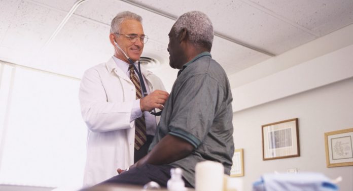 Male doctor examining a male patient