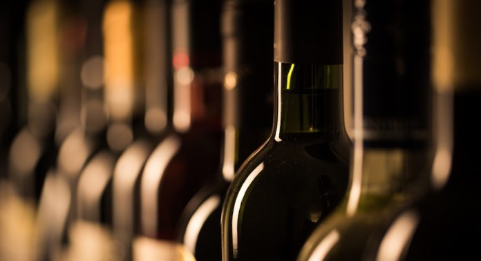 Row,Of,Vintage,Wine,Bottles,In,A,Wine,Cellar,(shallow