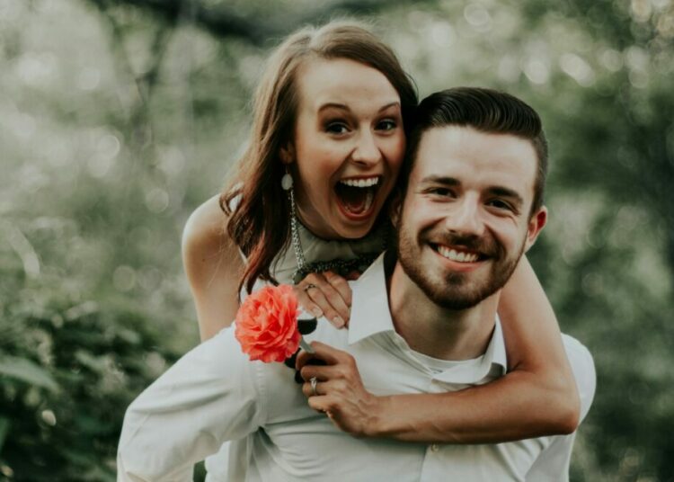 We were walking through a park with trails leading into the forests, when we saw this breathtaking coral flower… my sister ran and got it and jumped on her husbands back… right then and there is where is captured this priceless image.